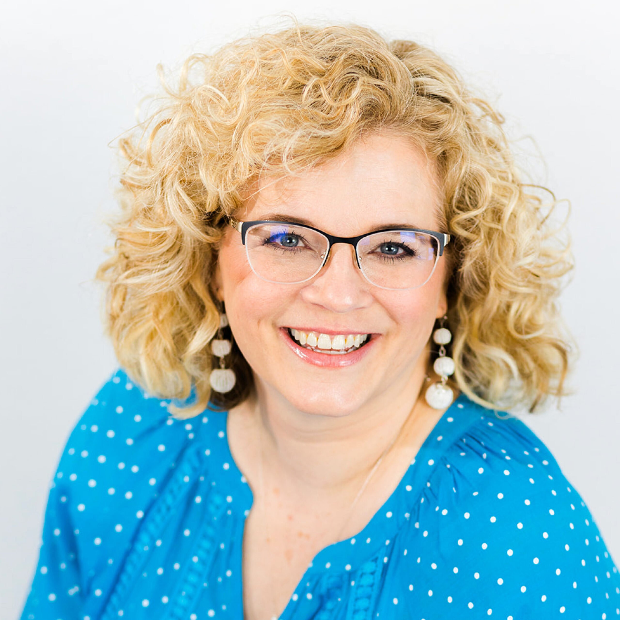 Chelly in blue shirt smiling.