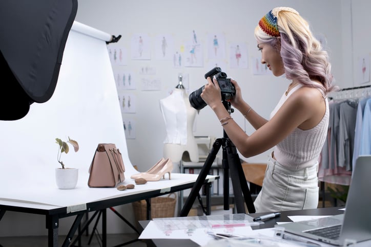 Lady taking pictures at her own online business.