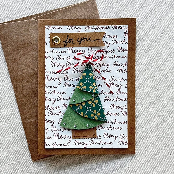 Folded tree on a kraft paper with matching envelope.