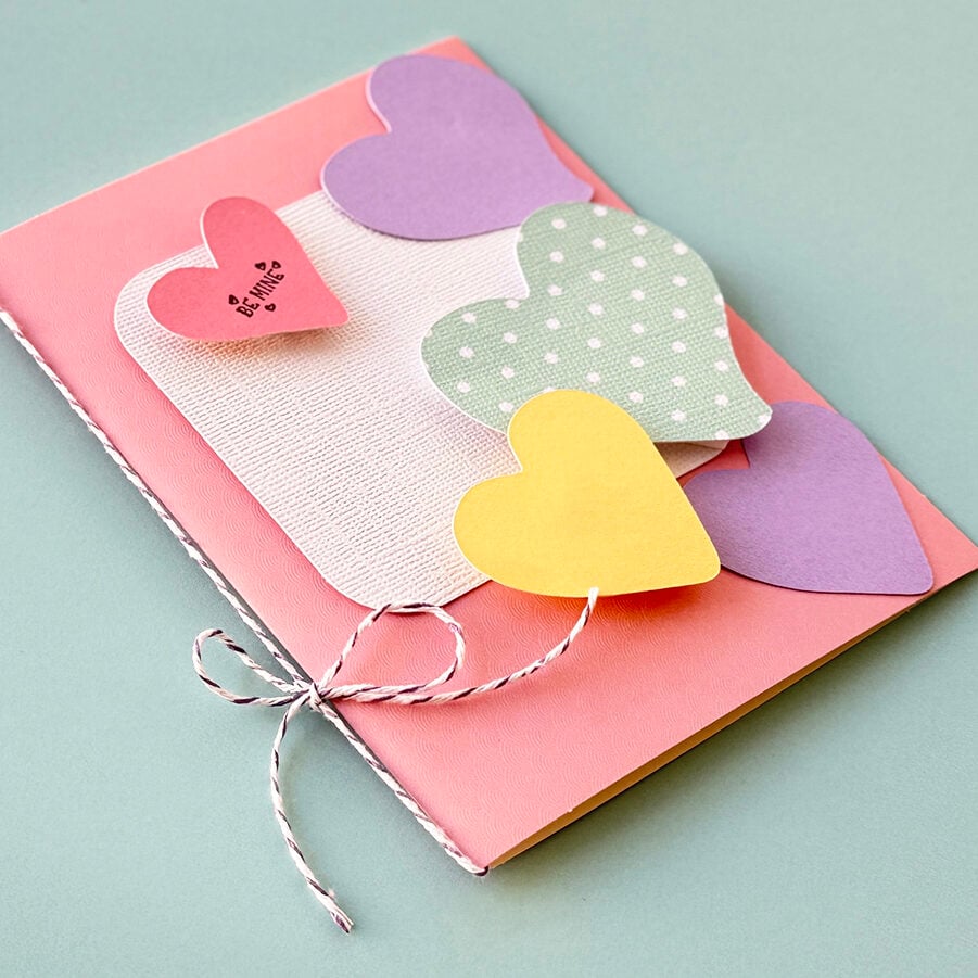 Handmade Pink card with hearts on a mint green background.