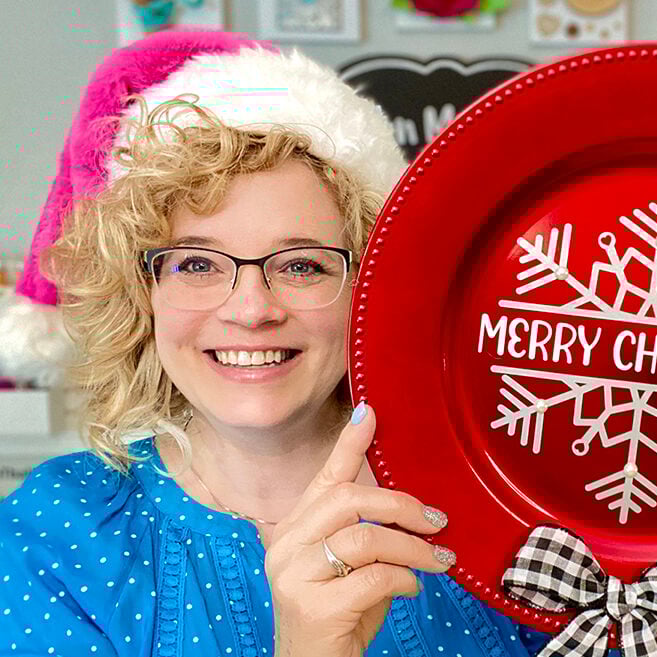 chelly with pink santa hat holding snowflake sign.