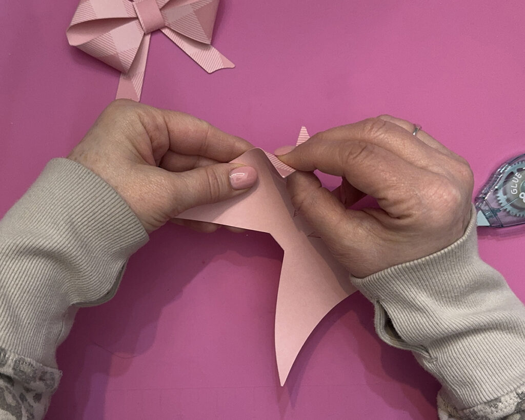 Folding the pink paper bow from SVG file idea.