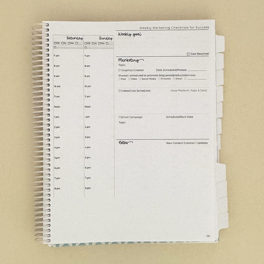 Small business planner on tan, open to weekend view.