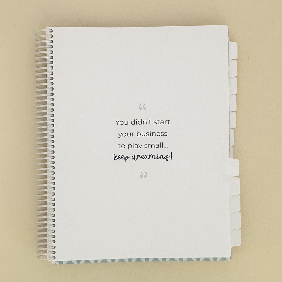 Small business planner on tan, open to tab view.