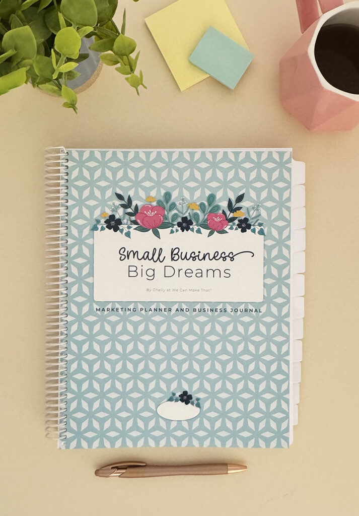 Small business planner on tan, with ice blue cover.